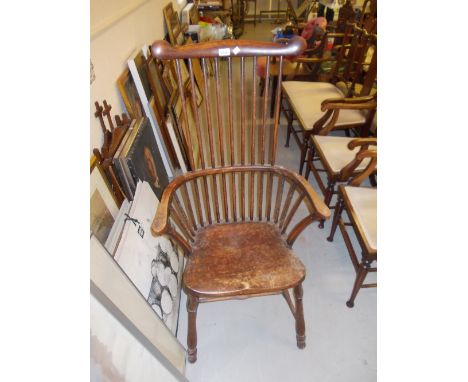 Early 20th Century beechwood comb and spindle back elbow chair with panel seat on turned supports