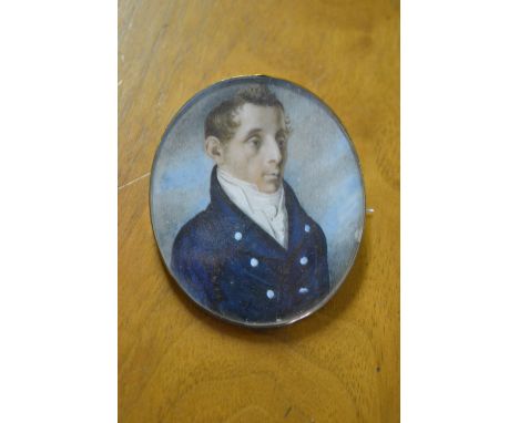 19th Century oval head and shoulder portrait miniature of a gentleman in blue overcoat with a ruff collar, unsigned, 2ins hig