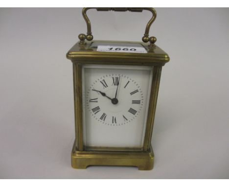 Small 20th Century brass cased carriage clock with enamel dial having Roman numerals and single train movement
