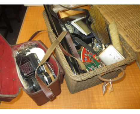 Picnic hamper containing a quantity of miscellaneous items including: two SLR cameras, collection of cap badges, boxes, photo