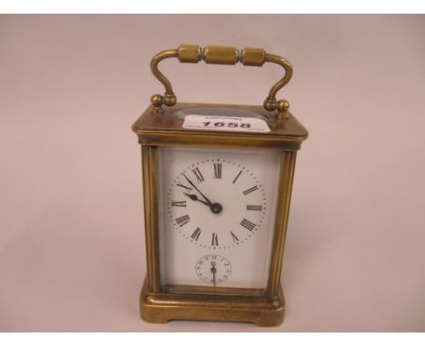 Early 20th Century gilt brass cased carriage clock having enamel dial with Roman numerals and subsidiary alarm dial striking 