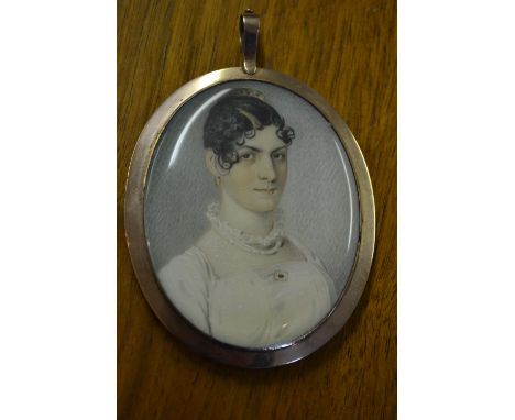 18th / 19th Century oval head and shoulder portrait miniature of a young lady in a white dress, housed in a gold plated mount