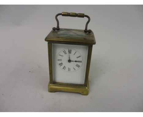 Small brass cased carriage clock, the enamel dial with Roman numerals and single train movement