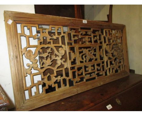 Early 20th Century Chinese framed carved and pierced window panel decorated with flowers, bats and scroll, 20ins x 42ins