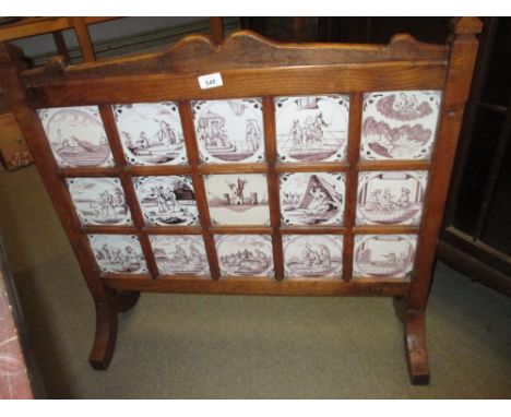 Group of fifteen 18th Century Delft ware tiles, later mounted in an oak firescreen