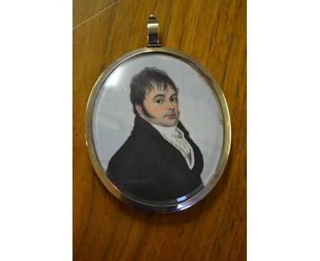 Early 19th Century head and shoulder portrait miniature of a gentleman in a blue overcoat with ruff collar, in a gold plated 