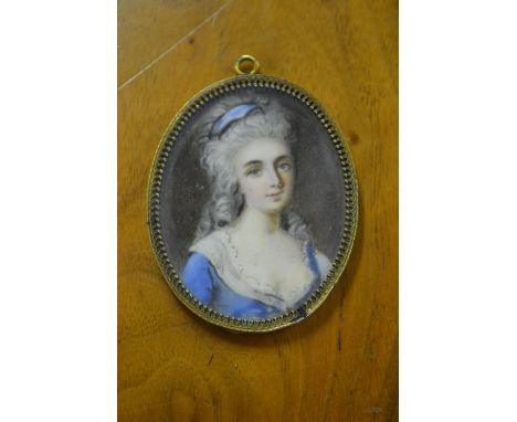 Late 18th / early 19th Century oval portrait miniature, head and shoulder portrait of a young lady in a blue dress, gilt meta