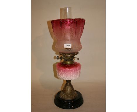 Victorian brass and opaque glass oil lamp with cranberry glass shade