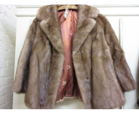 Ladies short light coloured fur jacket