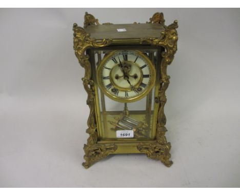 Late 19th or early 20th Century French gilt brass four glass library clock, the enamel dial with Roman numerals and visible e