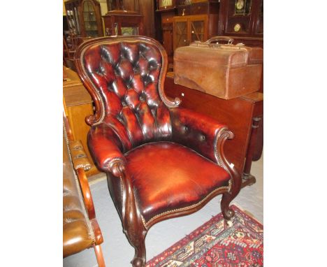 19th Century red leather button upholstered spoonback armchair, raised on carved cabriole front supports with brass and ceram