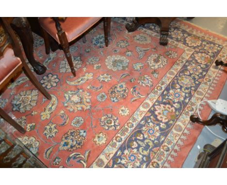 Large Indo Persian carpet of all-over floral design with multiple borders on a salmon ground, approximately 10ft x 8ft