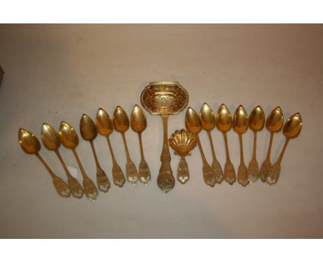 19th Century French silver gilt sugar sifter spoon together with a set of fourteen French silver gilt spoons with a matching 