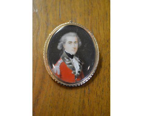 Late 18th / early 19th Century oval portrait miniature of an officer in red overcoat (possibly on porcelain), in a yellow mou