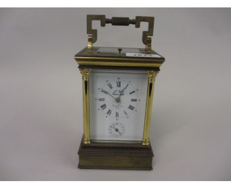 20th Century brass cased repeating carriage clock having enamel dial with Roman numerals and alarm dial, inscribed Lepee with