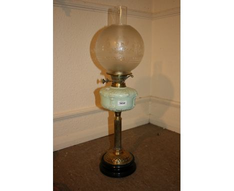 Victorian brass oil lamp with a blue glass well and an etched glass globe shade