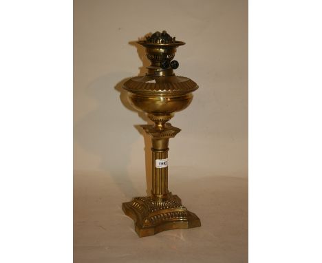 Late 19th or early 20th Century brass oil lamp and well with clear glass shade and chimney