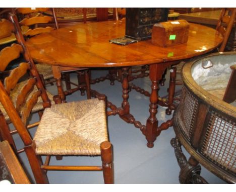 Good quality reproduction yew wood gate leg table on baluster turned supports with stretchers together with a set of six matc