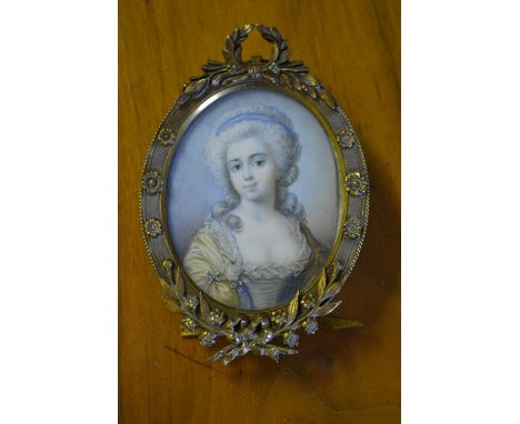 Late 19th or early 20th Century watercolour portrait miniature of a girl in 18th Century costume, mounted in a gilt metal fra
