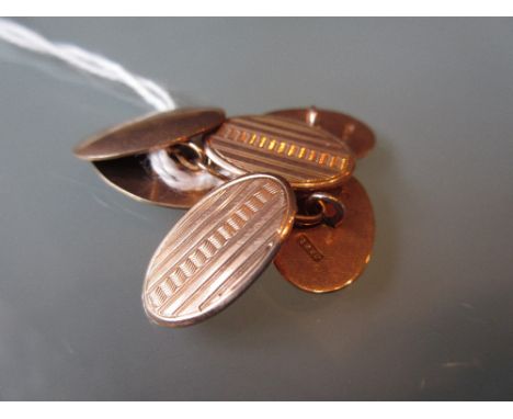 Pair of 9ct Gold engine turned cufflinks together with another single 9ct gold cufflink