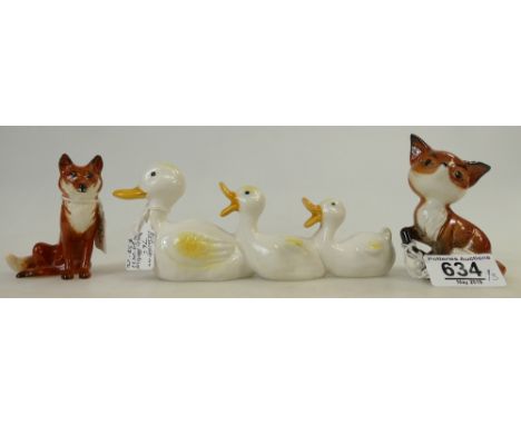 Three ceramic items: Beswick Comical Fox 1733, Seated Fox 1748 and comical duck family 765. (3)