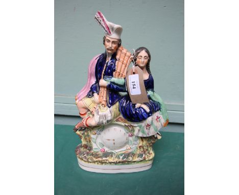 Large Staffordshire Victorian flatback 'clock' figure of a Scotsman and his lady companion