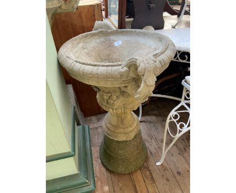 Urn shaped stone garden planter on circular base