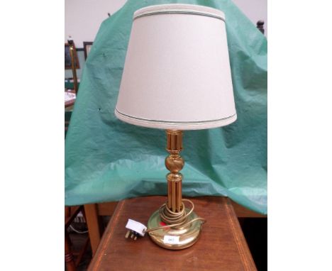 Brass table lamp with beige parchment shade