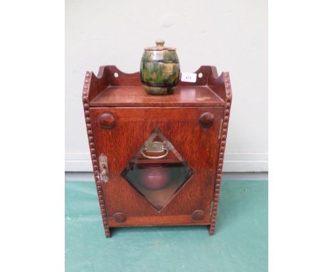 Oak smokers cabinet inset glass diamond bevel edged glass door and contents incl. various pipes, 2 tobacco jars, damaged ambe