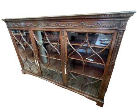 Edwardian mahogany astragal glazed three door bookcase on bracket feet, 122cm by 188cm by 37cm.