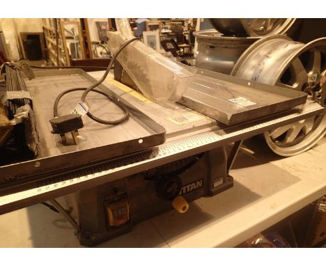 Titan table top saw. Not available for in-house P&P, contact Paul O'Hea at Mailboxes on 01925 659133Condition Report: All ele
