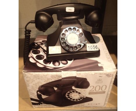 The GPO 200 rotary telephone has a metal base and handset; traditional cloth handset curly cord & is compatible with standard