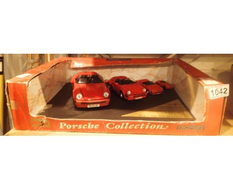 Boxed set of four model Porsche cars. P&amp;P Group 2 (£18+VAT for the first lot and £3+VAT for subsequent lots) 