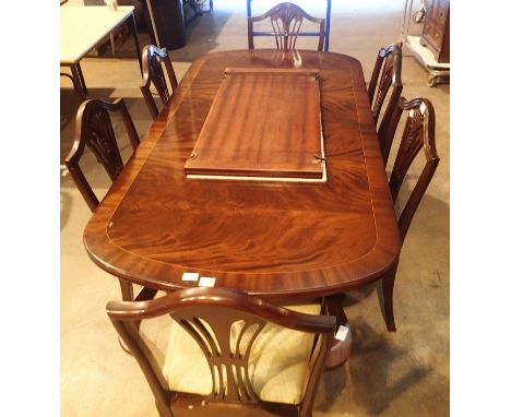 Reproduction dining table with dual tripod base and a set of four plus two mahogany dining chairs. Not available for in-house