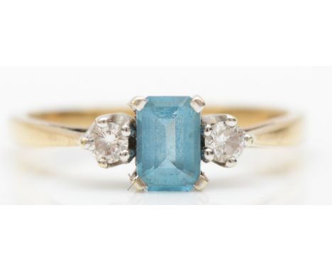 A 9ct gold blue topaz and diamond three stone dress ring, O, 2gm. 