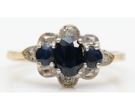 A 9ct gold three stone sapphire and illusion set diamond dress ring, K-L, 1.9gm. 