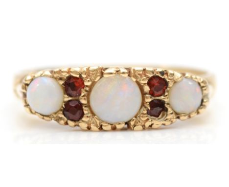 A 9ct gold three stone opal and garnet dress ring, L, 3.2gm. 
