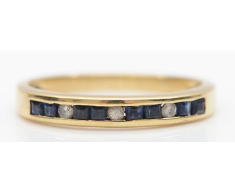 A 9ct gold channel set sapphire and diamond dress ring, L-M, 1.5gm. 