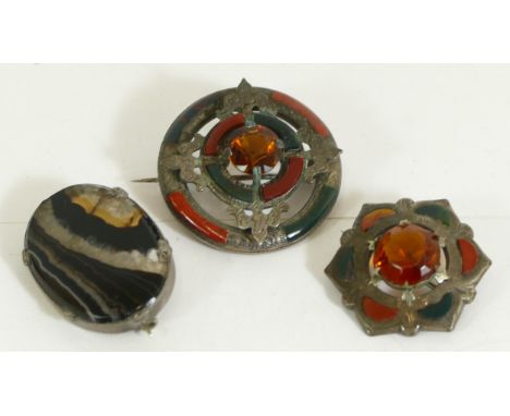 A Victorian Scottish silver and hardstone Celtic brooch, 37mm, an Edwardian example and a silver mounted hardstone brooch, 26