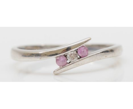 A 9ct white gold, brilliant cut diamond and pink sapphire three stone ring, N 1/2, 1.9gm 