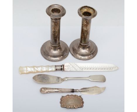 A Victorian silver and mother of pearl handled bread knife, a silver Sherry ladle, two knives and a pair of loaded silver can