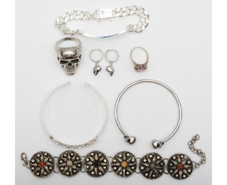 A 925 stamped silver ID bracelet, a pair of skull earrings stamped 925, an unmarked skull ring and bangle and two other bangl
