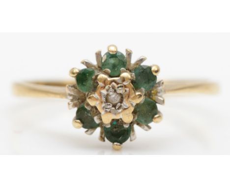 A 9ct gold emerald and illusion set diamond cluster ring, N, 1.4gm. 