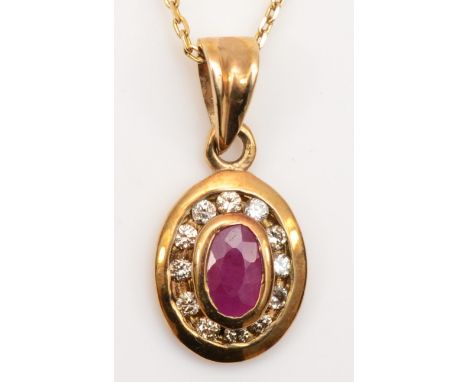 A 9ct gold ruby and diamond oval cluster pendant, on 375 chain, clasp missing, 17mm, 1.7gm. 