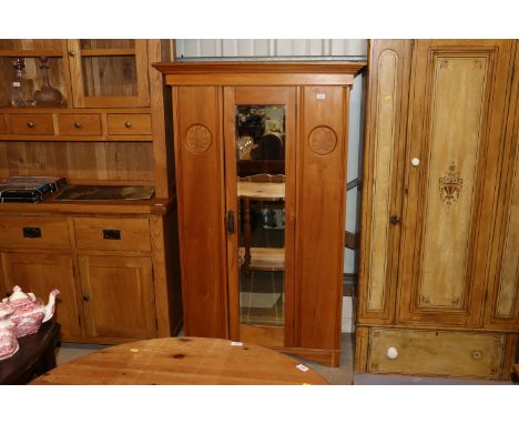 An Edwardian satin walnut mirror door wardrobe 