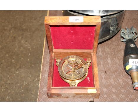 A cased brass compass