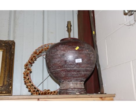 A large terracotta converted table lamp and shade 