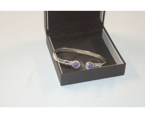 A 925 silver and purple stone set bangle 