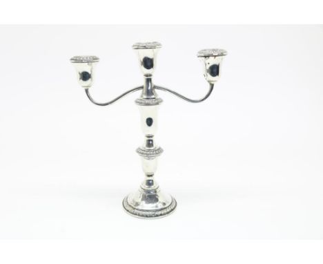 Silver candle stick holder, can be enlarged to a three  candle candalabra, filled, 925/000, max. height 25 cm. Dents.Zilveren