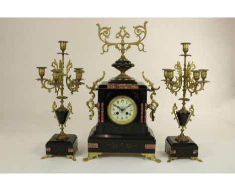 Mantle clock in black lacquered case, with matching candle  holders, France, 19th century.Pendule in deels zwartlak kast met 